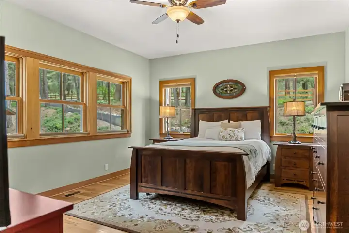 Main floor primary suite offers plenty of room for furnishings and large walk-in closet.