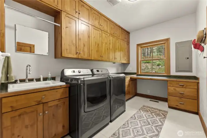 Large laundry room with abundant storage.