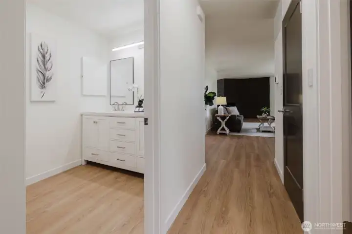 Looking back toward the living room, kitchen from bedroom 1. Main bath to left of the photo.