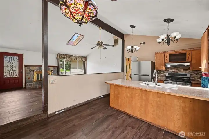 The open kitchen is designed with entertaining in mind, showcasing a large peninsula with the sink facing outward, allowing you to stay connected with family and guests.
