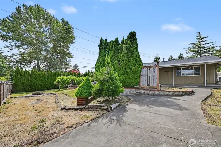 Backyard also feature charming walkways, fire pit, and storage shed.