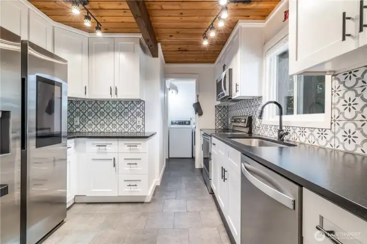 Totally updated kitchen including cabinets, flooring, leathered granite counters and SS appliances