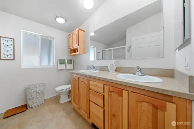 Primary bathroom features double sinks, counterspace and lots of cabinets and drawers.