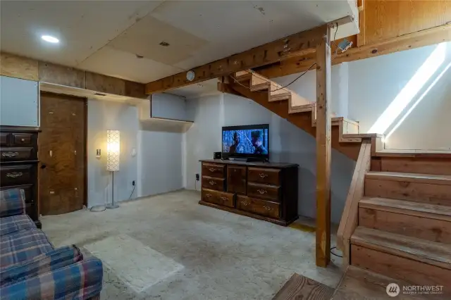 Downstairs room with utility room off to side, providing exrta storage