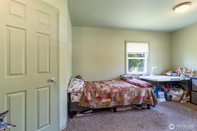 Primary bedroom w/ walk in closet, door to bathroom