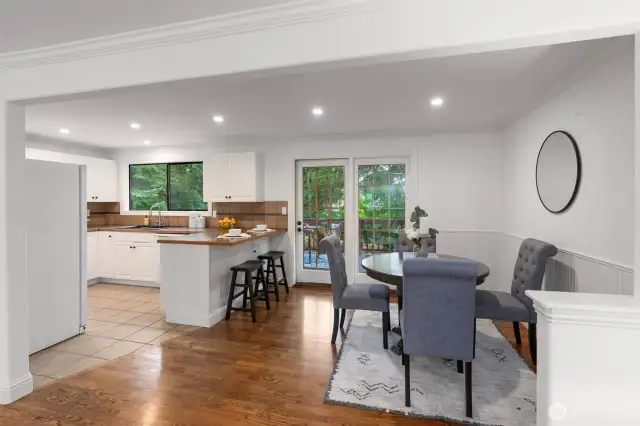 Dining and kitchen space with bar seating.
