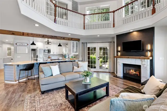 Great room area and island  kitchen open to 2nd story above, french doors to the breezeway and guest quarters beyond.