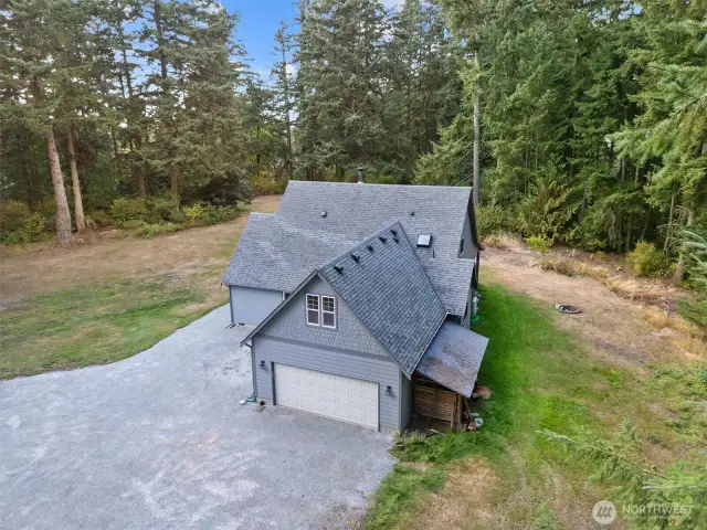 This energy-efficient home features a main floor primary suite, Bamboo floors, Euroline tilt & turn windows, convection radiant heat, Hickory cabinets, skylights, vaulted ceilings, custom Honeycomb window treatments & woodstove with blower.