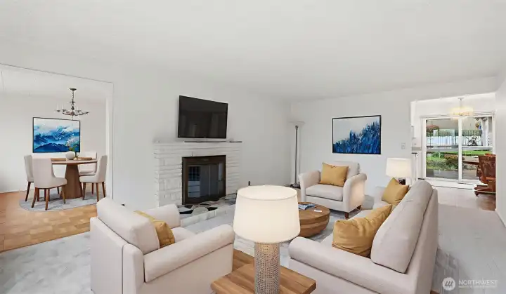 Virtually staged to show off the flexible layout, charming fireplace, and connection to dining spaces.