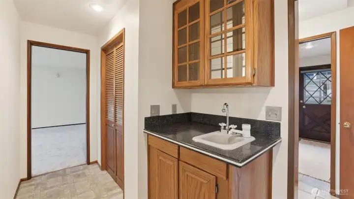 Convenient hallway wet bar area offering extra storage and functionality.