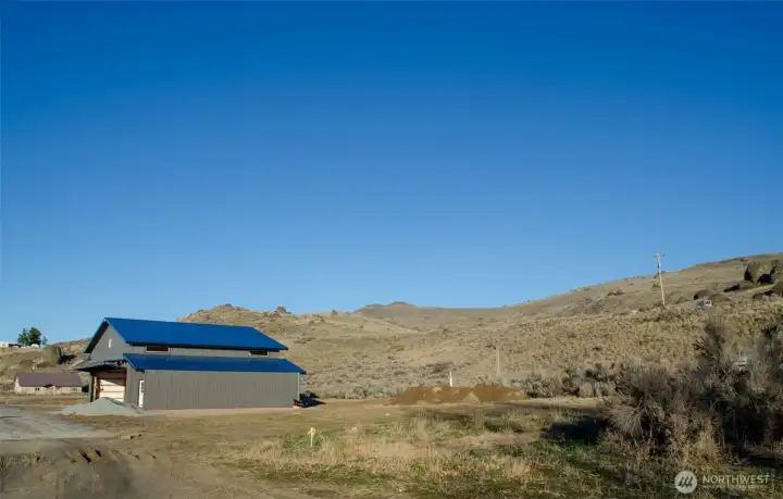 To the right of the neighbor's existing hangar is the 50'X300' easement where you can build your own hangar.