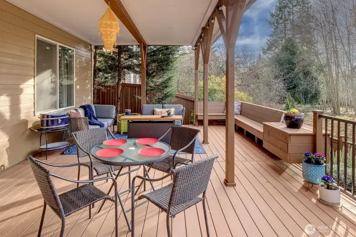 The lower level deck is covered for those rainy days....ideal for firepit fun and again, simply surrounded by a nature...not, neighbors! Low maint terra tech decking w/custom seating and storage, heat lamps too! This is one fun place + space!