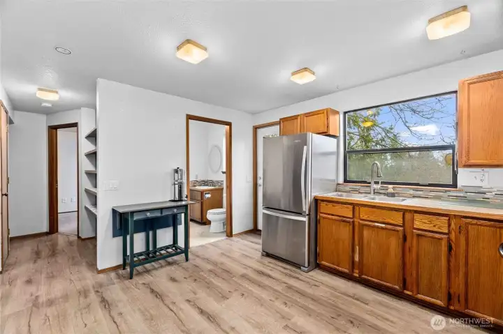 Convienient half bath off the kitchen, and downstairs office or bedroom on the left.