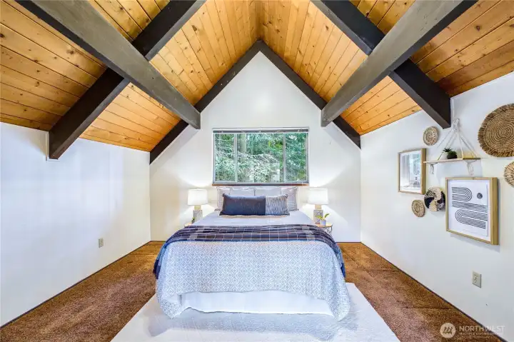 Spacious loft bedroom with closets on both sides