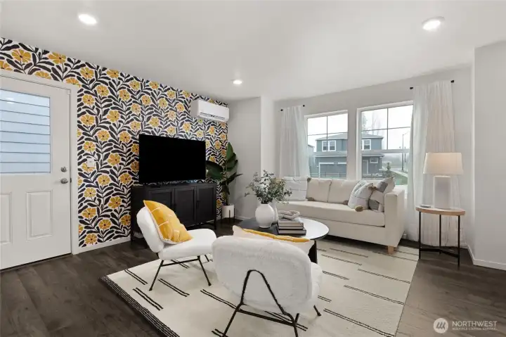 Open-concept great room filled with natural light from large windows, creating a bright and welcoming living space. Living Room - Photos are for representational purposes only, colors, elevation and features may vary.