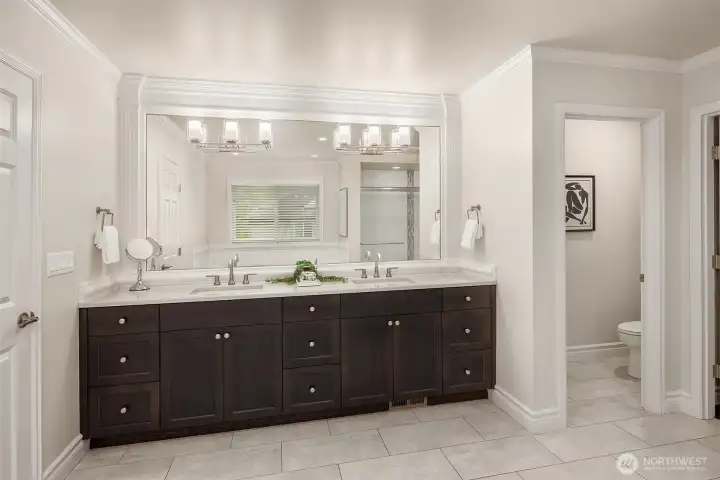 Dual vanities provide abundant storage and functionality.