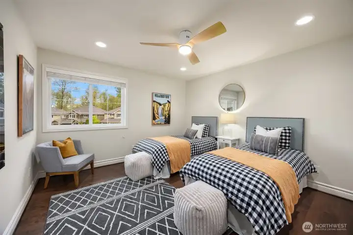 Upper level bedroom #3 features a ceiling fan and a custom closet design, creating a comfortable and inviting retreat.