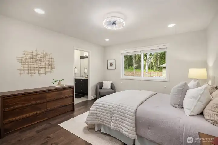 Bedroom #4 is well-appointed with a ceiling fan and custom closet system. Two bedrooms are adjoined by a shared full bath.