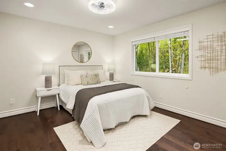 Upper level bedroom #5. Two bedrooms  are adjoined by a shared full bath. Each space includes a ceiling fan and custom closet system for comfort and organization.