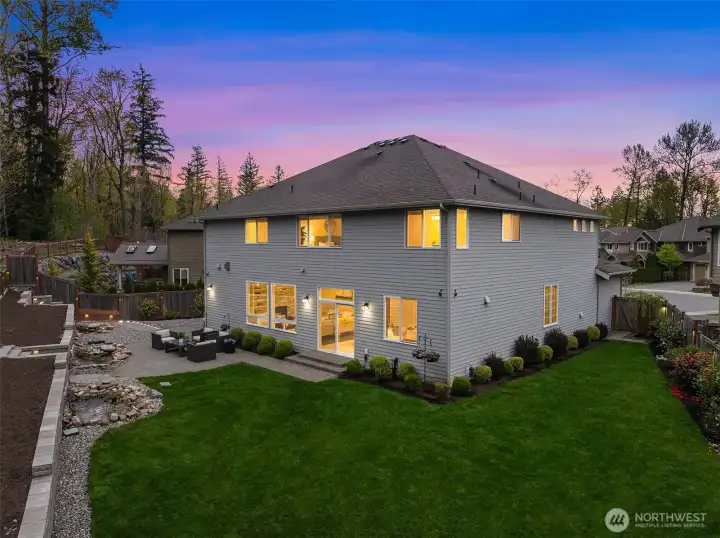 A private, fully fenced outdoor retreat features an expansive patio ideal for entertaining. Manicured, professional landscaping with triple Koi ponds and water features create a feeling of Zen with nature.