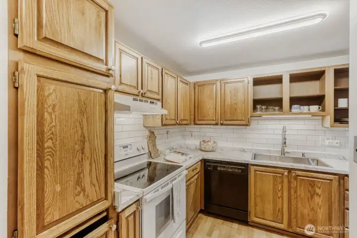 Updated countertops, tile backsplash, sink and lighting in the kitchen