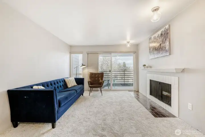 Living room with wood burning fireplace, and slider to your private deck.  New carpets in the LR/DR.