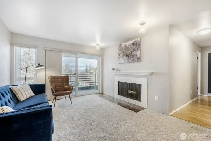 Living room with wood burning fireplace, and slider to your private deck.  New carpets in the LR/DR.