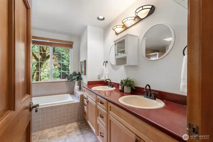 Spacious Primary bath includes jetted tub, updated flooring, sinks, recessed lighting, and fixtures. Spacious Primary bath includes jetted tub, updated flooring, sinks, recessed lighting, and fixtures.