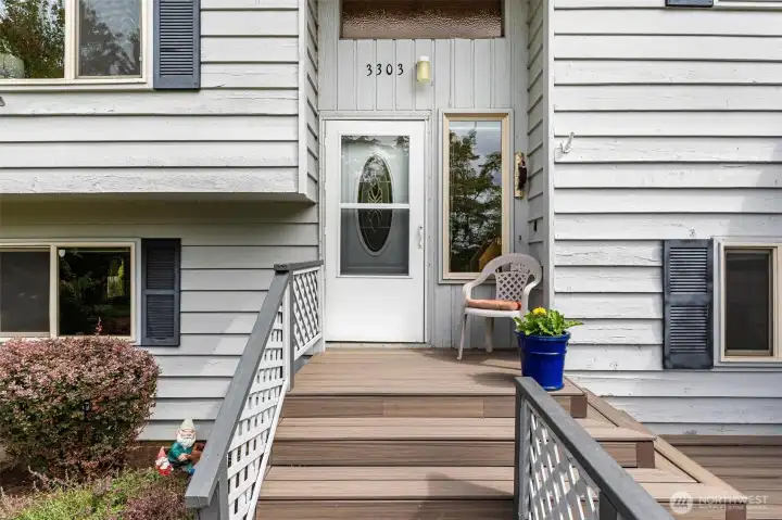 Welcoming front entry with a wide staircase, meticulously maintained landscaping and composite deck. Welcoming front entry with a wide staircase, meticulously maintained landscaping and composite deck.