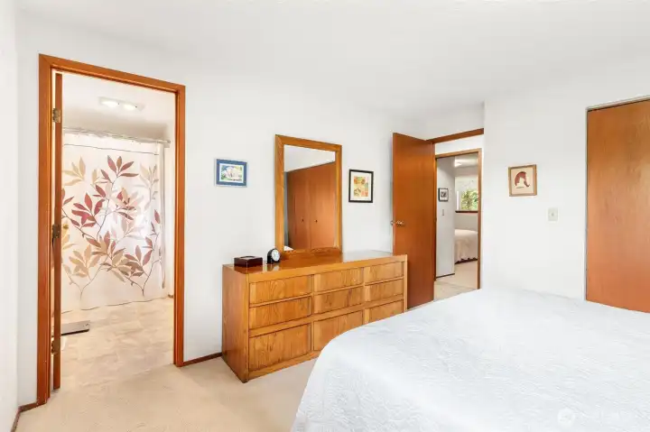 Peaceful primary bedroom with plush carpeting and natural light. Peaceful primary bedroom with plush carpeting and natural light.