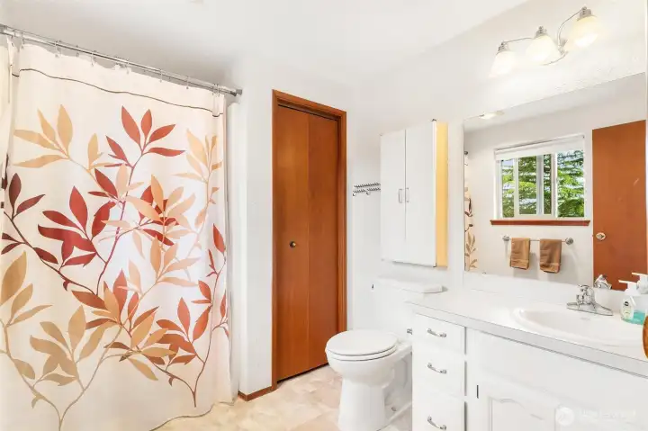 Private and bright primary bathroom with original wood accents. Private and bright primary bathroom with original wood accents.