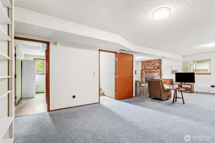 Additional angle of the lower level family room showing the open floor plan.Doorway to garage, utilities, and 1/2 bath Additional angle of the lower level family room showing the open floor plan.Doorway to garage, utilities, and 1/2 bath