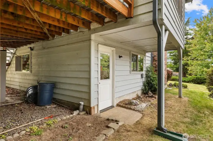 Rear exterior showing the lower level entrance and covered patio area. Rear exterior showing the lower level entrance and covered patio area.