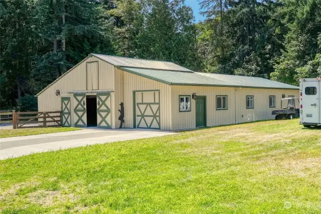 The barn is on the left side, and the overhead door on the right side opens up to the extra business/office space.  The business/office space is about 15 X 57 feet, insulated, and has a ductless heat pump and A/C.  The far end of the building has a carpeted space for the office.  It has been used for running a business in the past.