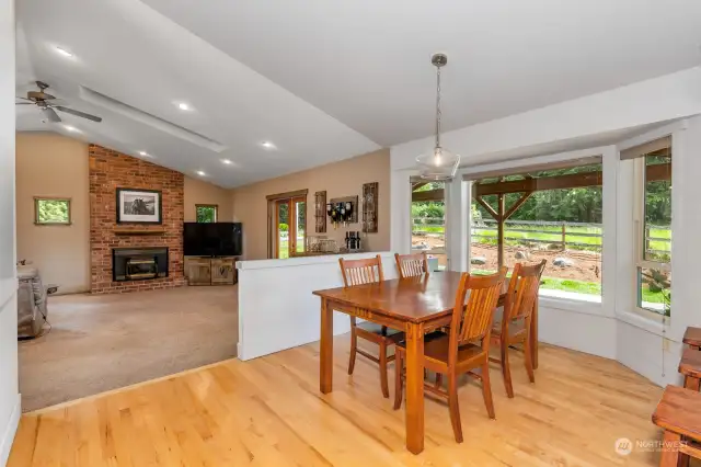 Dining room with hardwoods & bay window looking out to covered patio & beautiful rear yard.