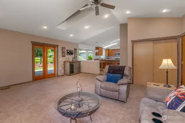 Family room with valulted ceilings, and french doors out to amazing covered patio.