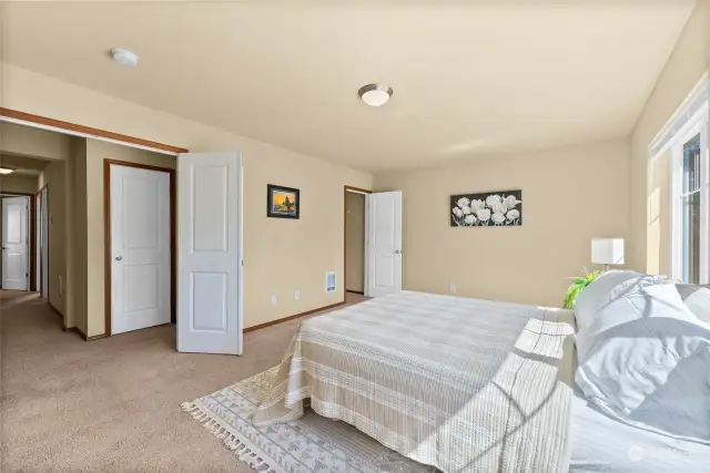 Another view of the primary bedroom showing a closet in the far right.