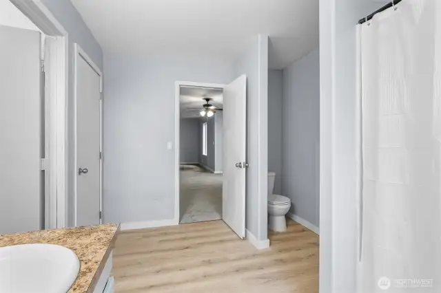 Primary bathroom, exiting perspective.