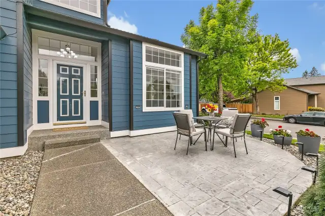 Though hard to see from the photo, the custom-stamped concrete patio showcases a striking Mariners emblem or compass design, adding a unique and personal touch to the outdoor space.