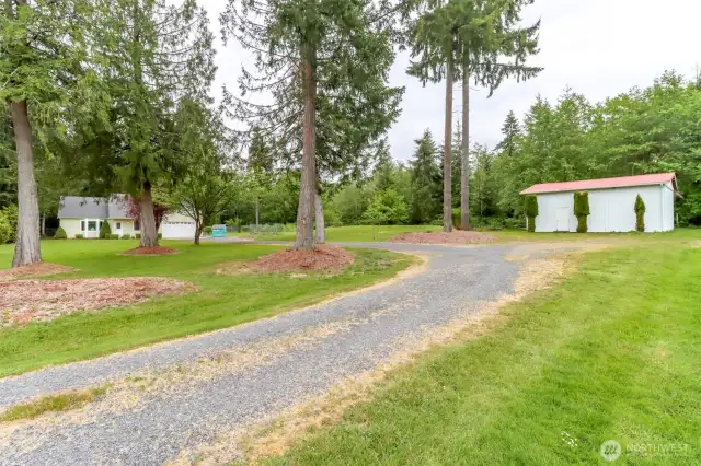 Driveway passed shop to home. Garden is between shop and home.