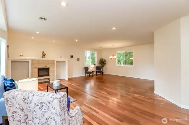 Hardwood floor welcome to open living room with Amish built electric fireplace.