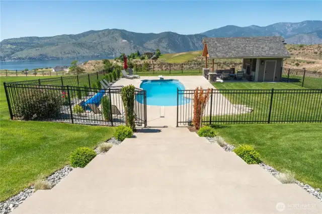 Stairs leading down to the fenced pool area