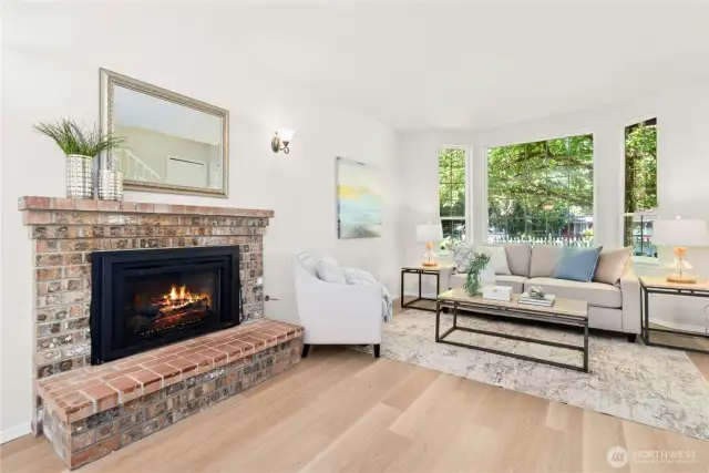 Large open concept living and dining areas with fireplace.