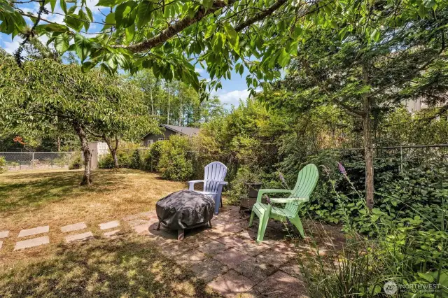 Look at this wonderful backyard seating complete with firepit