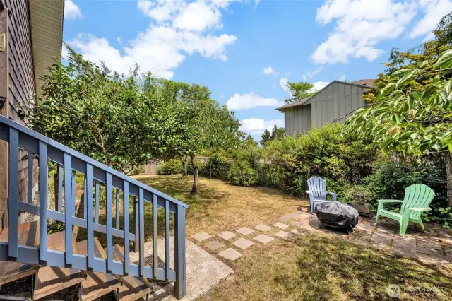 Another view of backyard with trees and flowers