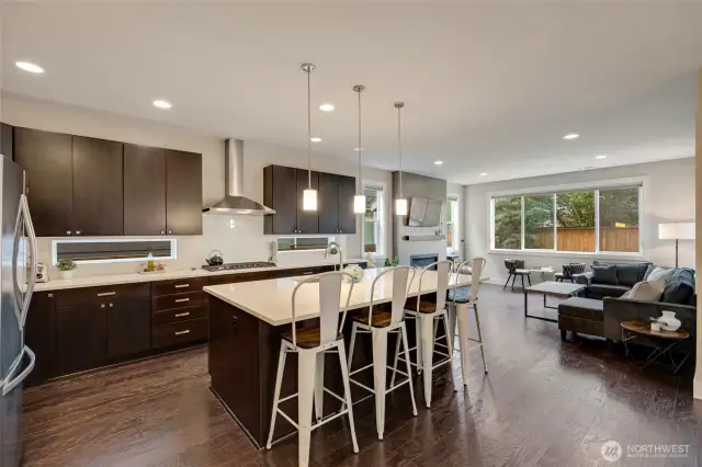 High end finishes include quartz counters, cherry cabinets, stainless appliances, tile fireplace with gas insert, and hardwood flooring.