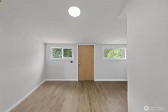 Utility room with door leading to back deck.