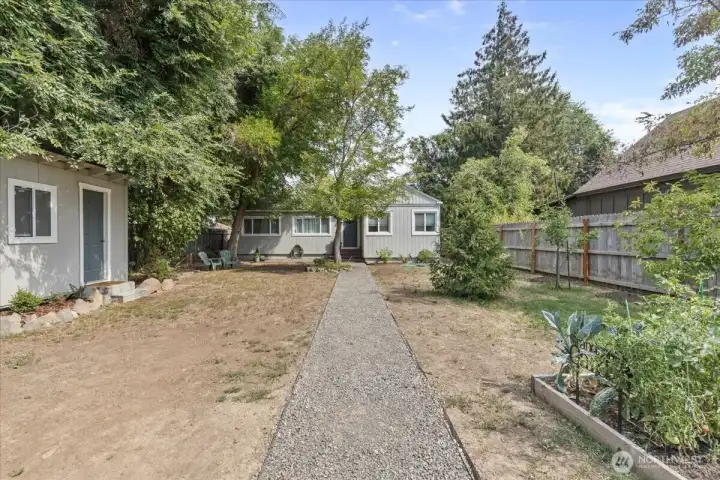 Garden area with storage shed. Mature fruit trees and large trees for shade to keep cool.