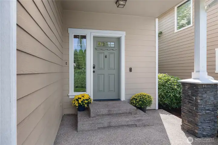 An inviting first impression greets you at the front door, highlighted by elegant stone pillar.