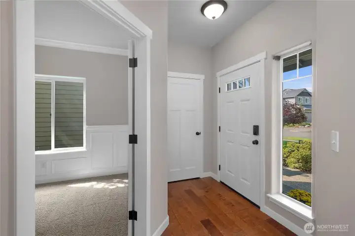 The entryway feautres a coat closet and a large window to create a welcoming entry space.